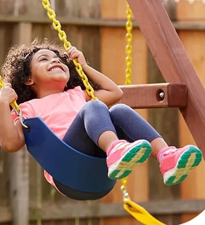 A child enjoying an outdoor swing, from the BuySwings.com collection.